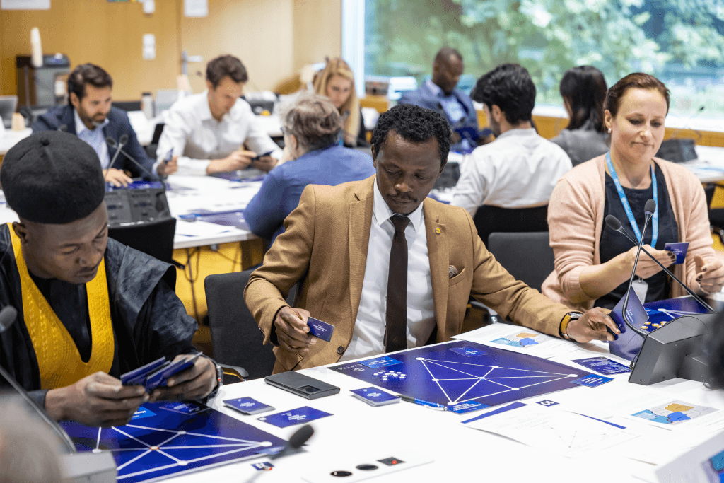 Group of diverse individuals playing board games in a workshop setting